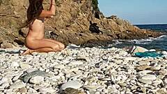 Naked Latina inserts pebbles on public beach solo walk